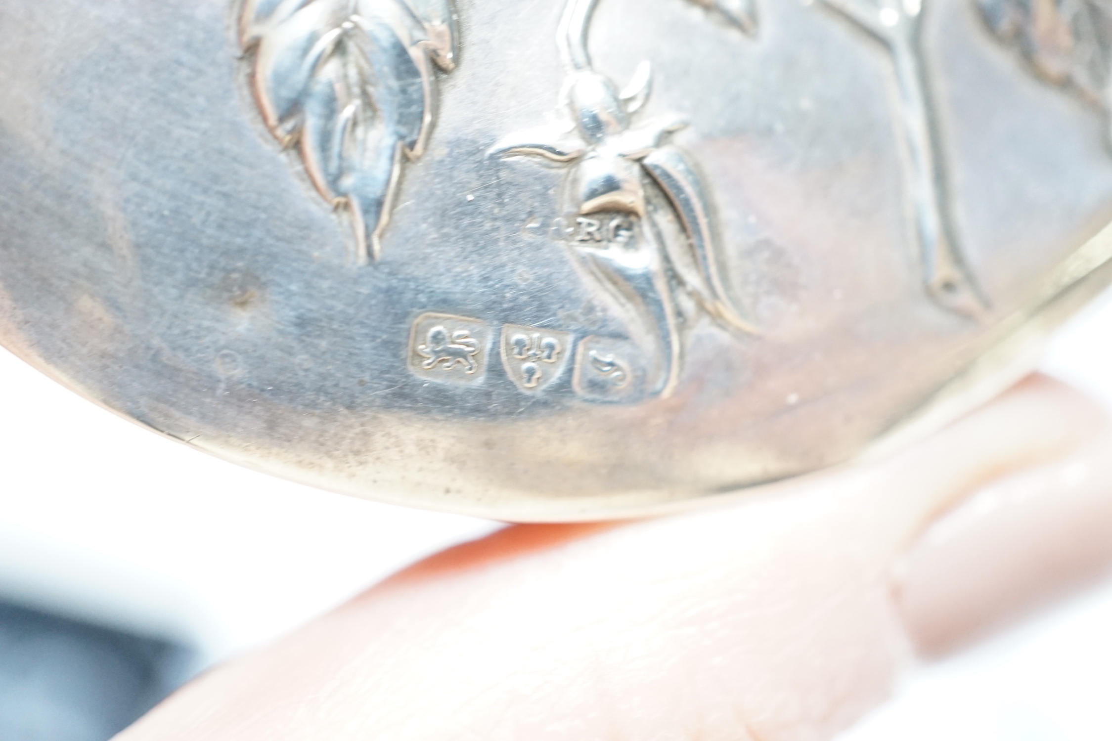 An Edwardian silver circular trinket box, embossed with a rose, Chester, 1909, 65mm, two modern pill boxes, silver and 800 standard with enamel and a modern Italian silver pill box.